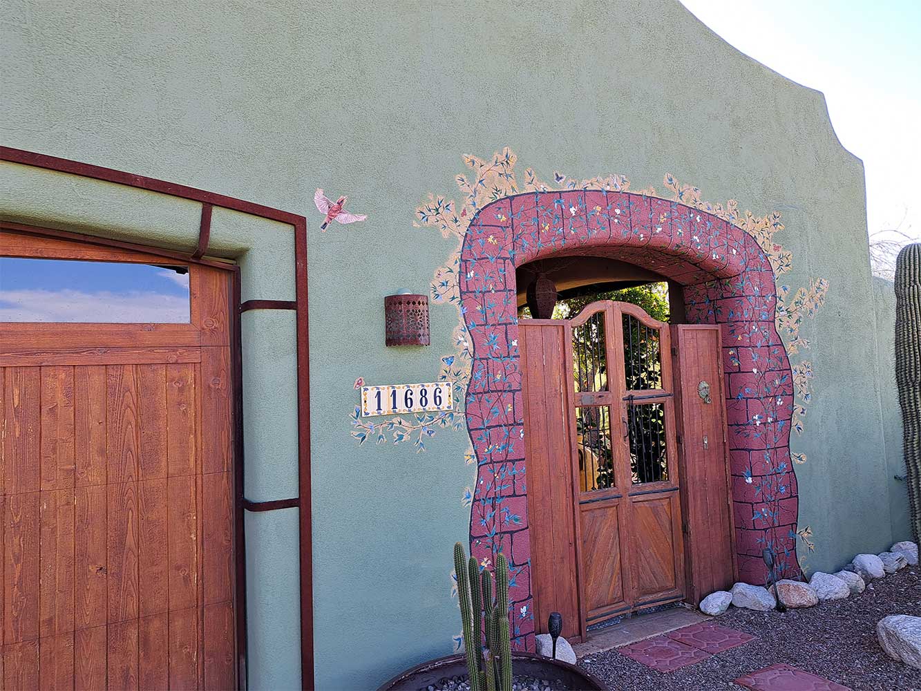 A building with a pink brick wall and door.