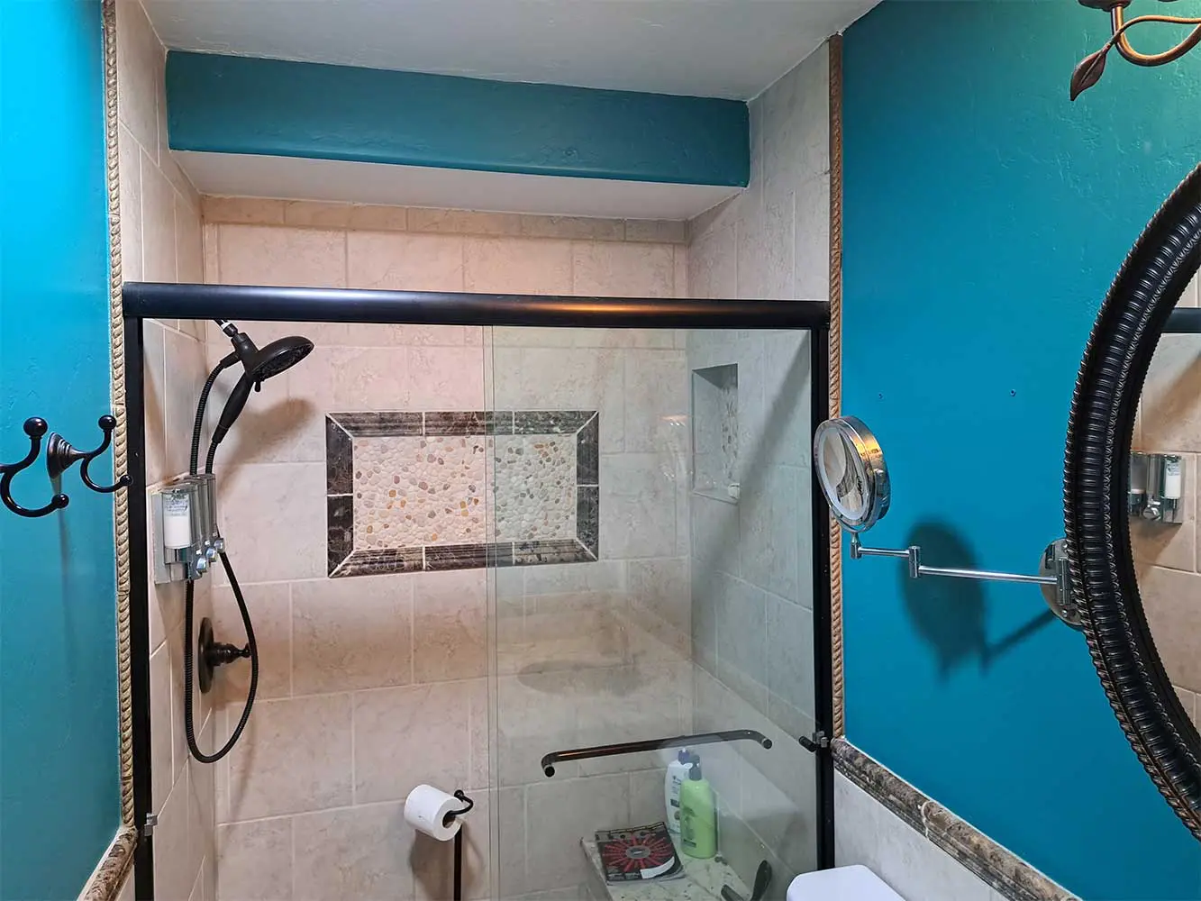 A bathroom with blue walls and white tile.