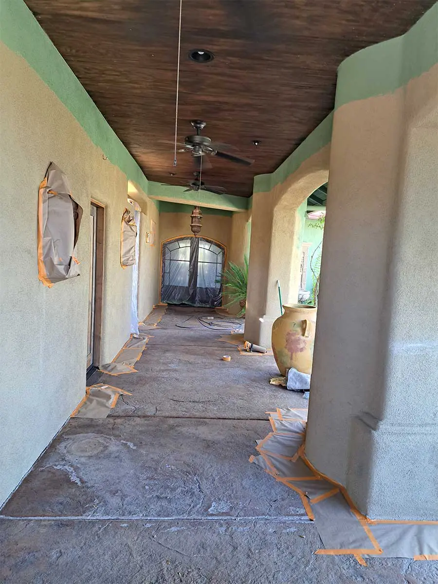 A hallway with many pillars and windows in it