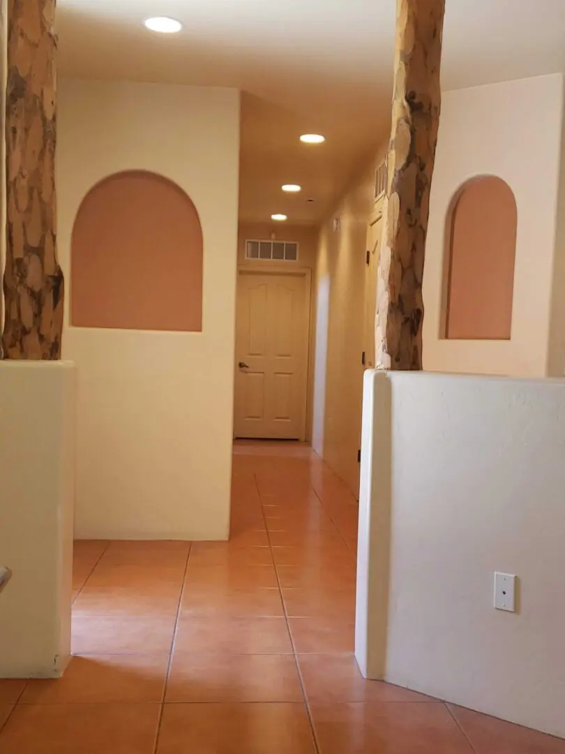 A hallway with two doors and three walls.