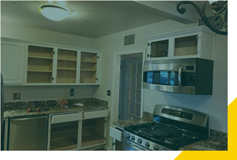 A kitchen with cabinets and stove in it